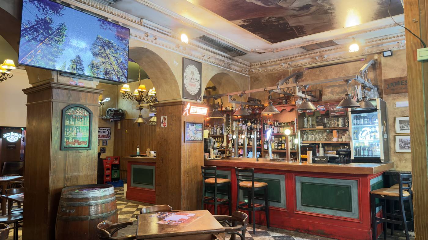 Bar counter and checkered floor inside Dubliners